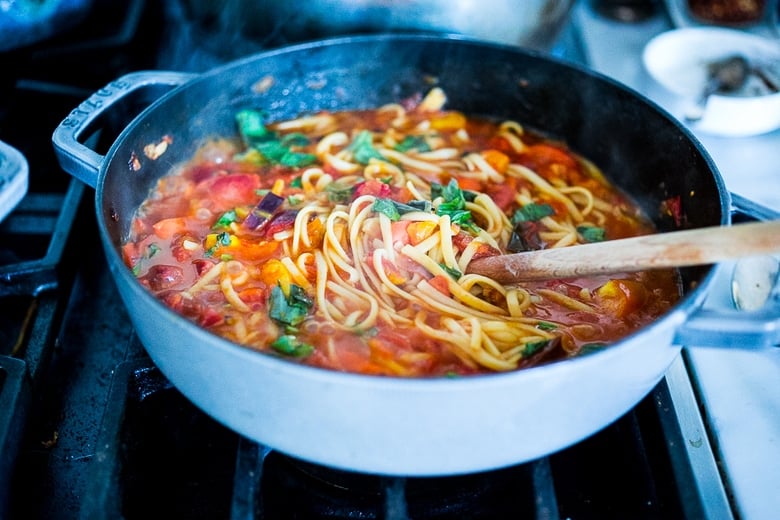 spaghetti and sauce cooking in a pan