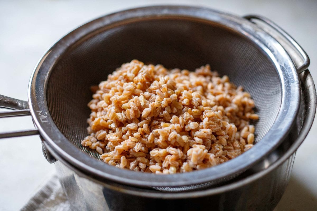 cooked farro being strained. 