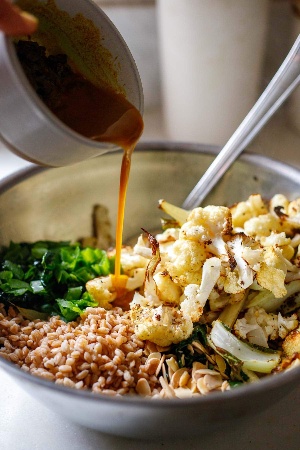 Pouring the dressing into the salad bowl. 