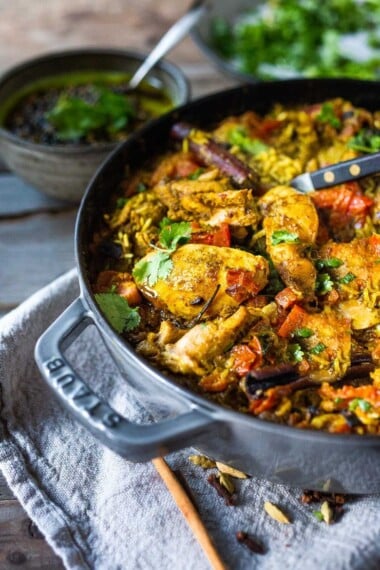 An authentic & insanely delicious recipe for Chicken Biryani with Cilantro Yogurt Sauce. | www.feastingathome.com #chickenbiryani #indianrice #indianchicken