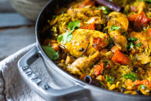 An authentic & insanely delicious recipe for Chicken Biryani with Cilantro Yogurt Sauce. | www.feastingathome.com #chickenbiryani #indianrice #indianchicken