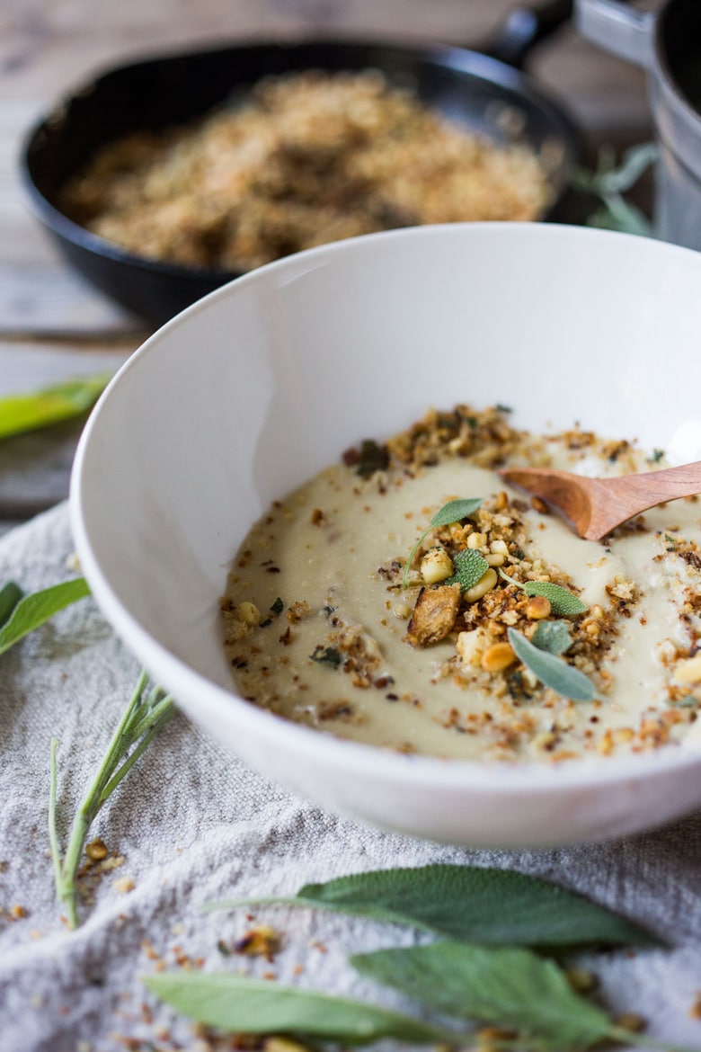 Creamy Cauliflower Soup with garlic and sage, topped with an optional pine nut"crumble" - healthy, quick and easy, perfect for weeknights when time is short. | #cauliflowersoup www.feastingathome.com