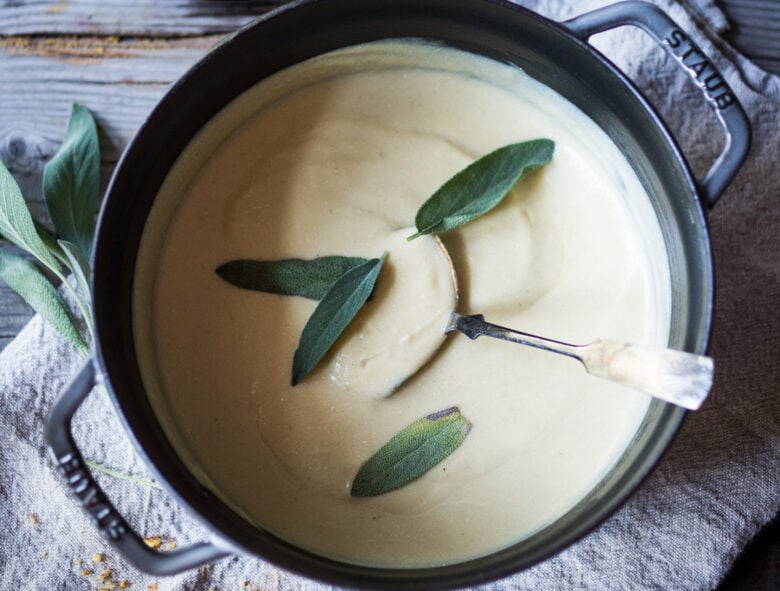 Creamy Cauliflower Soup with garlic and sage, topped with an optional pine nut"crumble" - healthy, quick and easy, perfect for weeknights when time is short. | #cauliflowersoup www.feastingathome.com