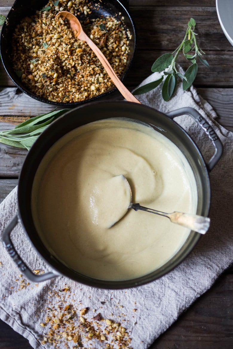 Creamy Cauliflower Soup with garlic and sage, topped with an optional pine nut"crumble" - healthy, quick and easy, perfect for weeknights when time is short. | #cauliflowersoup www.feastingathome.com