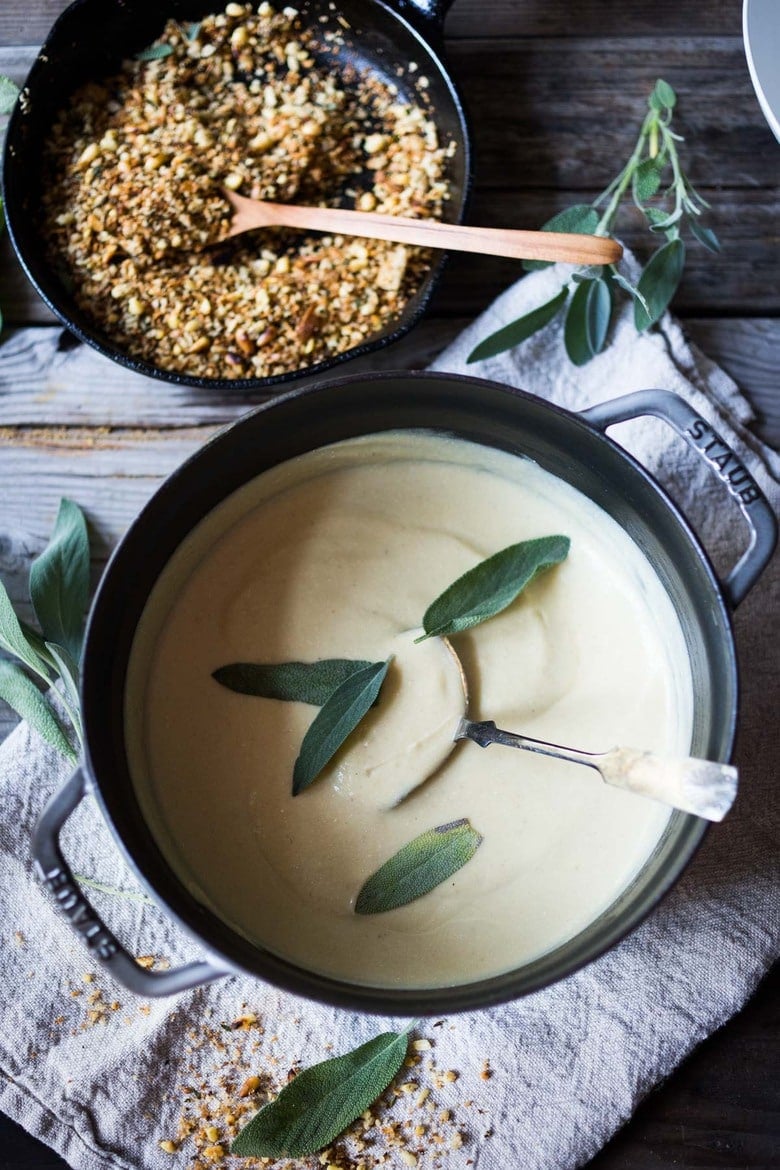 Creamy Cauliflower Soup with garlic and sage, topped with an optional pine nut"crumble" - healthy, quick and easy, perfect for weeknights when time is short. | #cauliflowersoup www.feastingathome.com