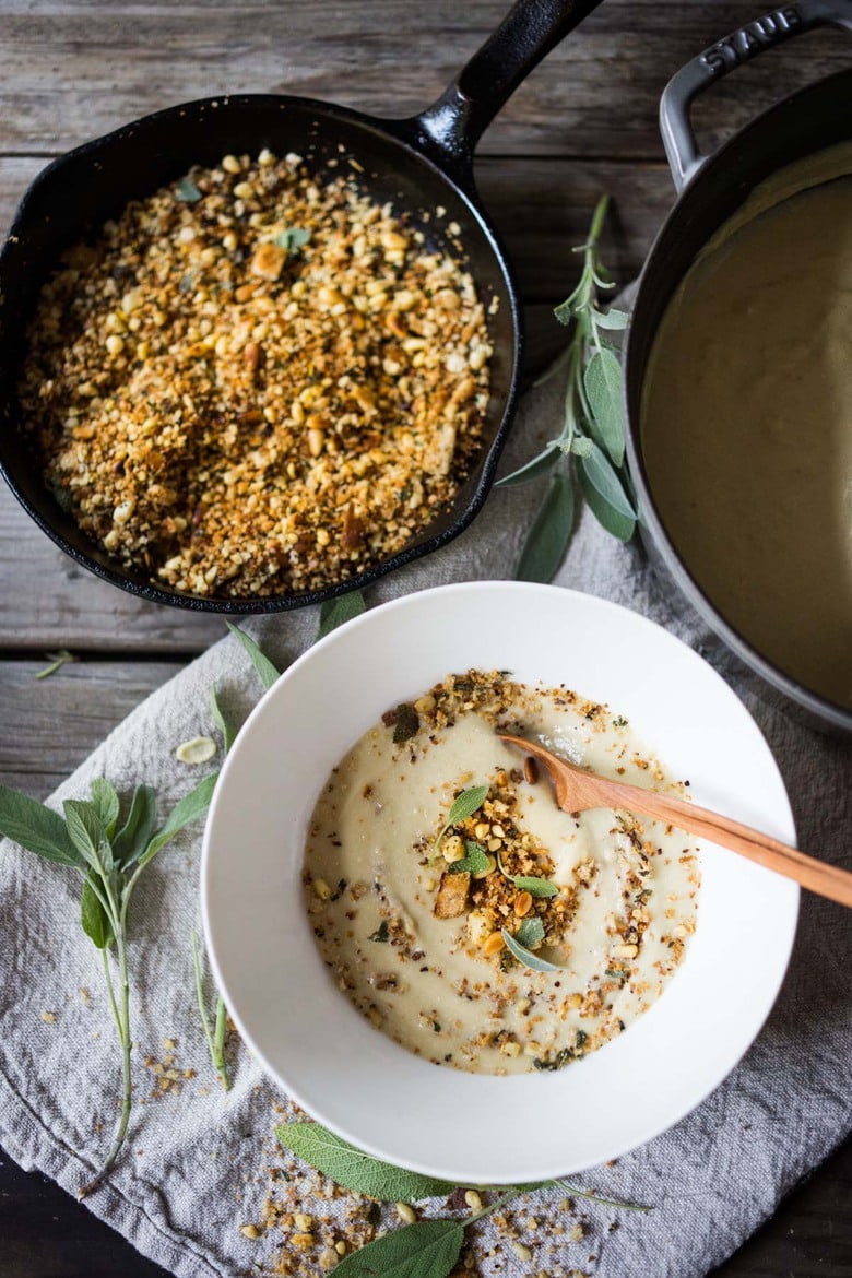 Creamy Cauliflower Soup with garlic and sage, topped with an optional pine nut"crumble" - healthy, quick and easy, perfect for weeknights when time is short. | #cauliflowersoup www.feastingathome.com