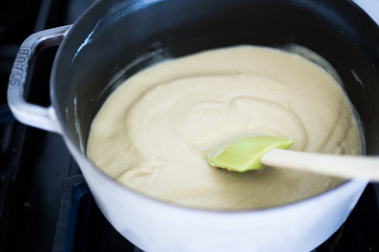 Parsnip Soup with hazelnuts, cardamom and thyme. A simple soup that can be made on the stovetop or roasted in the oven. Vegan Adaptable. #parsnipsoup #parsniprecipes #parsnips 