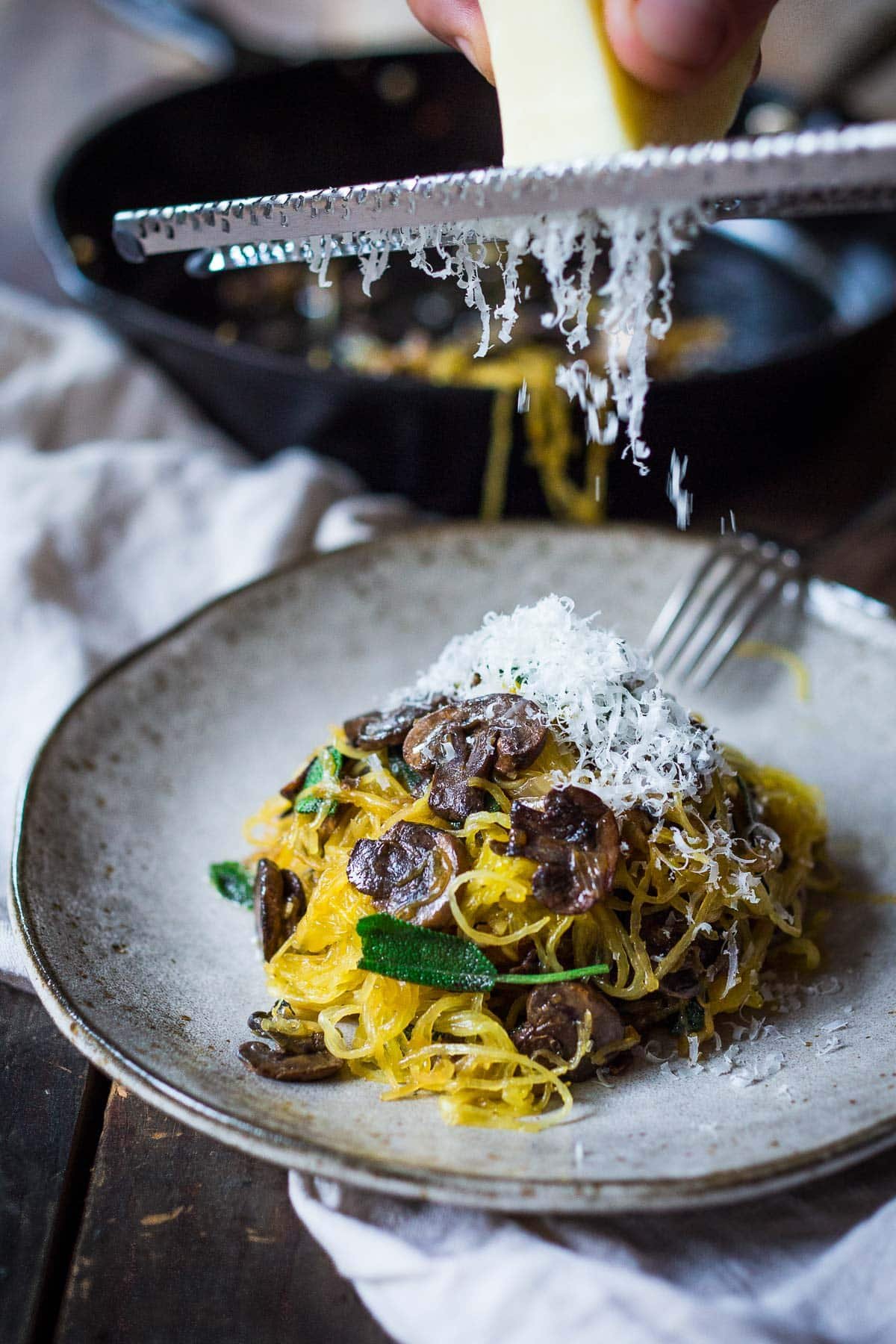 This delicious spaghetti squash recipe is made with a baked spaghetti squash, savory mushrooms, garlic, and sage-a flavorful, healthy vegetarian dinner! It's a low-carb, gluten-free meal that feels like a comforting pasta dish, perfect for fall. Keep it vegan or add pecorino cheese.