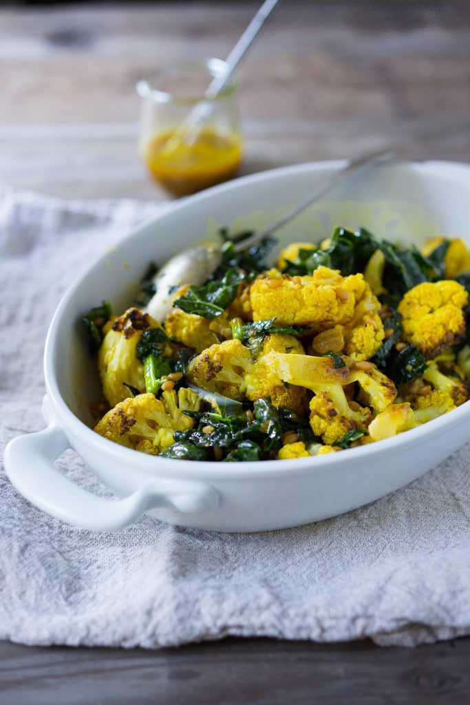 Roasted Cauliflower Salad with farro (or any cooked grain), lacinato kale and an earthy turmeric dressing. Delicious and healthy, it can be a served warm as a fall side dish, or chilled as a salad| www.feastingathom.com