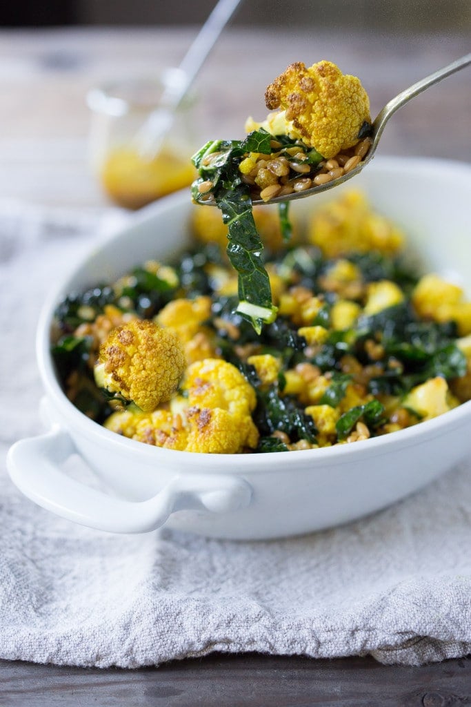 Roasted Cauliflower Farro Salad with lacinato kale and an earthy turmeric dressing. Delicious and healthy, it can be served warm as a fall side dish or chilled as a salad.
