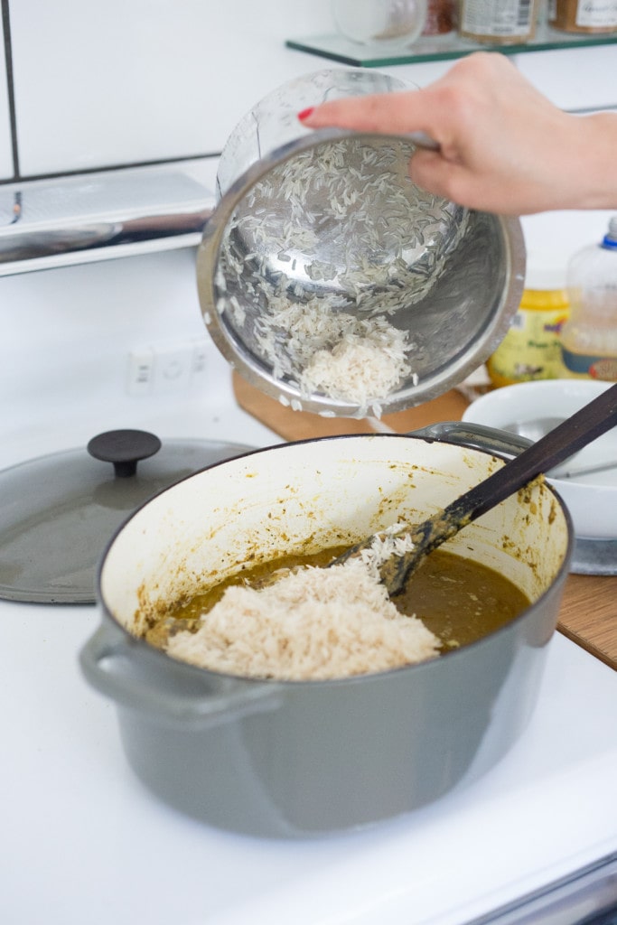 An authentic & insanely delicious recipe for Chicken Biryani with Cilantro Yogurt Sauce. Vegetarian option included as well as detailed step by step instructions. | www.feastingathome.com