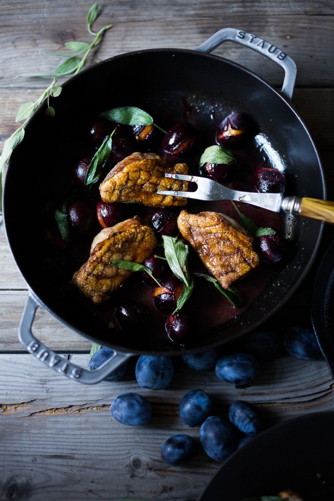 Crispy-skinned Duck with Roasted Plums, Cider Glaze and crispy sage- a simple elegant meal highlighting fall plums that can be made in 40 minutes! #duck #duckbreast #plums #roastedplums 