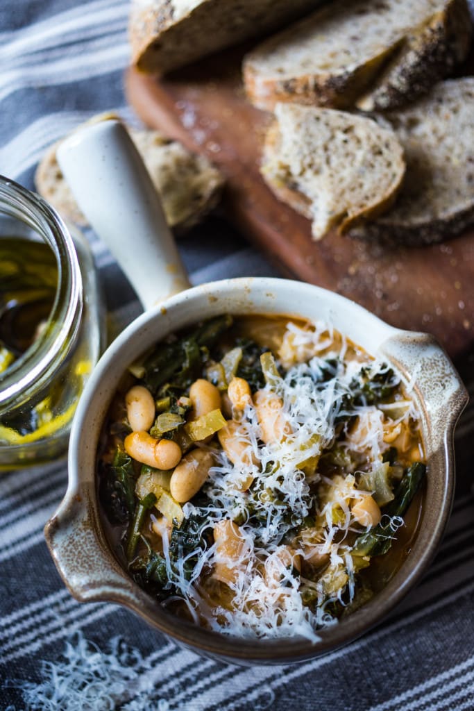 A healthy, delicious recipe for Tuscan Bean Soup called Ribollita - made with Cannellini beans, lacinato kale, and vegetables, drizzled with a Lemon Rosemary Garlic Oil. Hearty, nourishing, and easily vegan-Adaptable. (With a Video.)