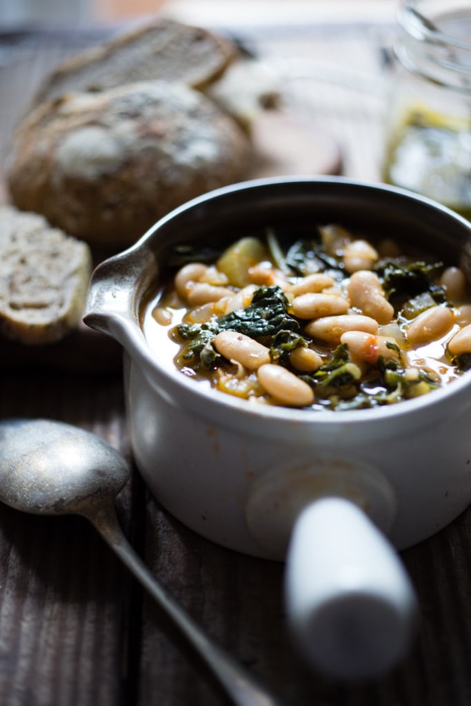 A healthy, delicious recipe for Tuscan Bean Soup called Ribollita - made with Cannellini beans, lacinato kale, and vegetables, drizzled with a Lemon Rosemary Garlic Oil. Hearty, nourishing, and easily vegan-Adaptable. (With a Video.)