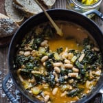 Tuscan Bean Soup Recipe called Ribollita made with with Cannellini beans, lacinato kale, and vegetables, served with crusty bread, drizzled with a Lemon Rosemary Garlic Oil. | www.feastingathome.com