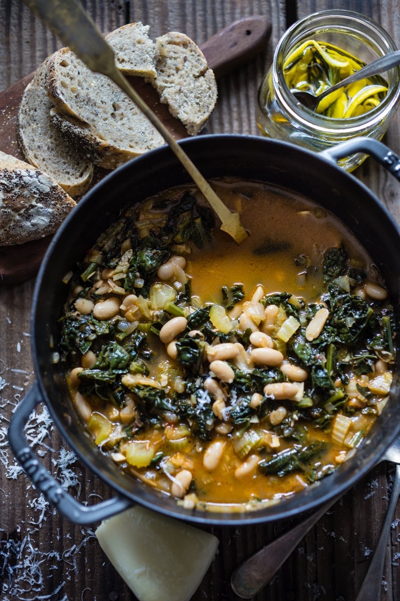 A healthy, delicious recipe for Tuscan Bean Soup called Ribollita - made with Cannellini beans, lacinato kale, and vegetables, drizzled with a Lemon Rosemary Garlic Oil. Hearty, nourishing, and easily vegan-Adaptable. (With a Video.)