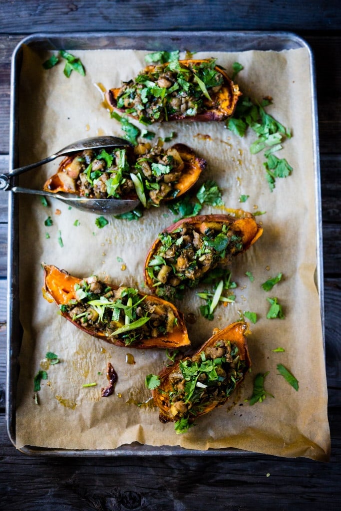 Healthy Moroccan Stuffed Sweet Potatoes w/ Ras El Hanout, chickpeas, apples, onion, garlic & cilantro is vegan, or drizzle with delicious smoked yogurt. | www.feastingathome.com @feastingathome