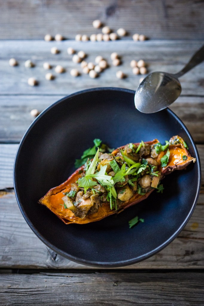 Healthy Moroccan Stuffed Sweet Potatoes w/ Ras El Hanout, chickpeas, apples, onion, garlic & cilantro is vegan, or drizzle with delicious smoked yogurt. | www.feastingathome.com @feastingathome