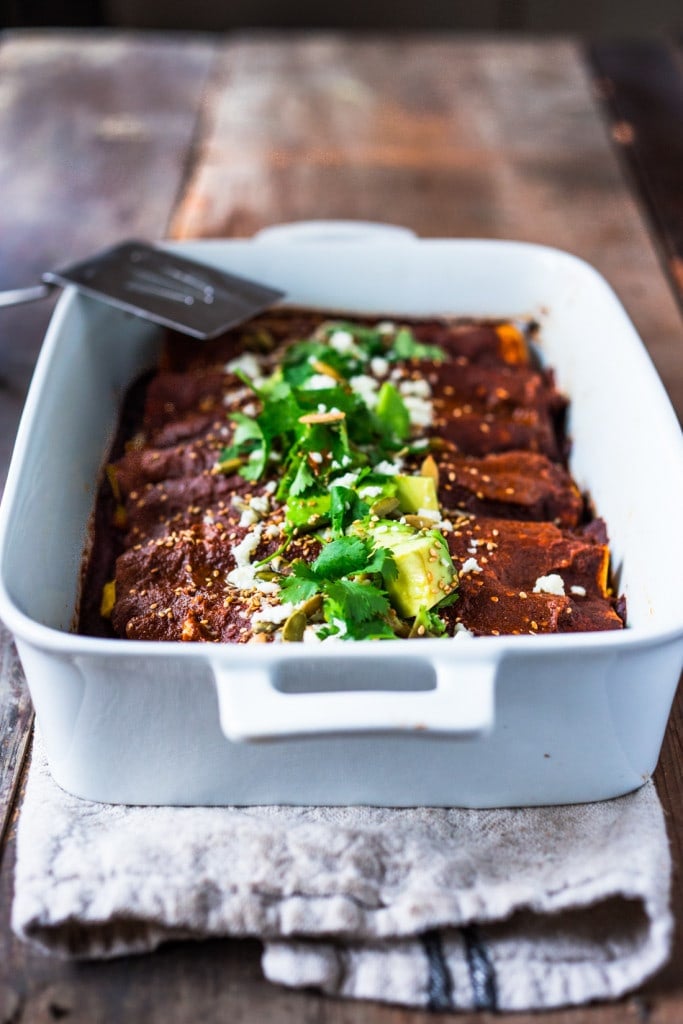 Vegetarian Butternut Squash and Black Bean Enchiladas are baked in a simple, flavorful Mole Sauce. A delicious vegetarian dinner, perfect for fall!  Vegan adaptable! 