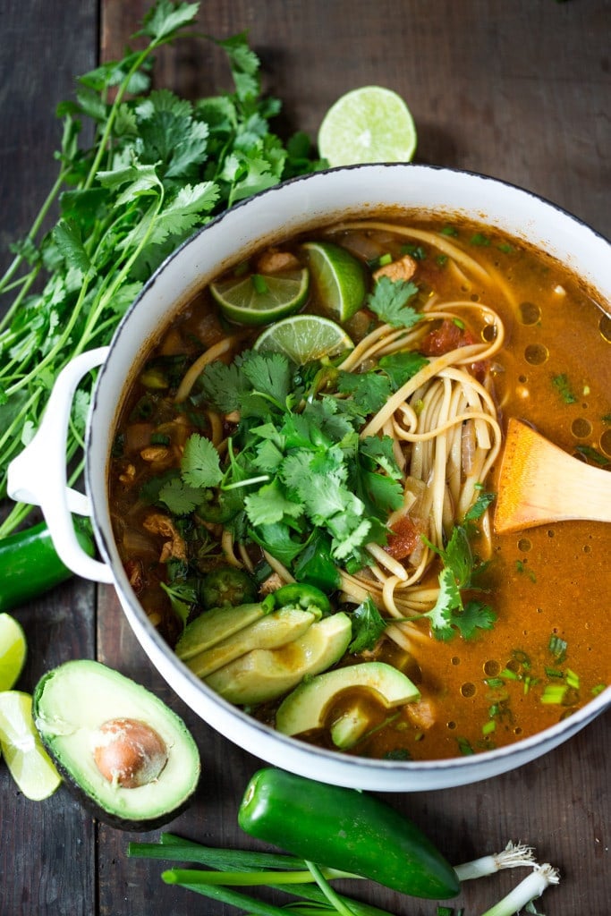 Mexican Noodle Soup in a pot with avocado and cilantro. 