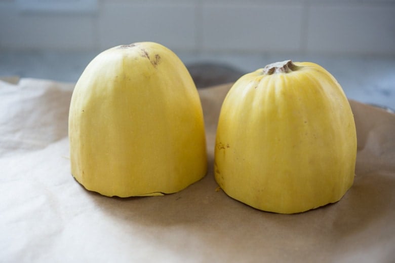 This robust and flavorful recipe for Roasted Spaghetti Squash with Eggplant Puttanesca, is healthy and gluten free! Easy and simple. | www.feastingathome.com