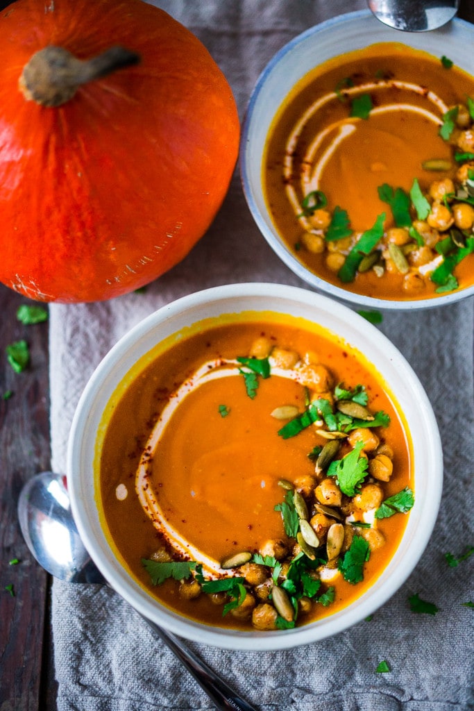 Roasted Kuri Squash Soup with Smokey Harissa, roasted crispy chickpeas and toasted pumpkin seeds, swirled with optional yogurt. | #kurisquash #kuri #roastedsquashsoup www.feastingathome.com