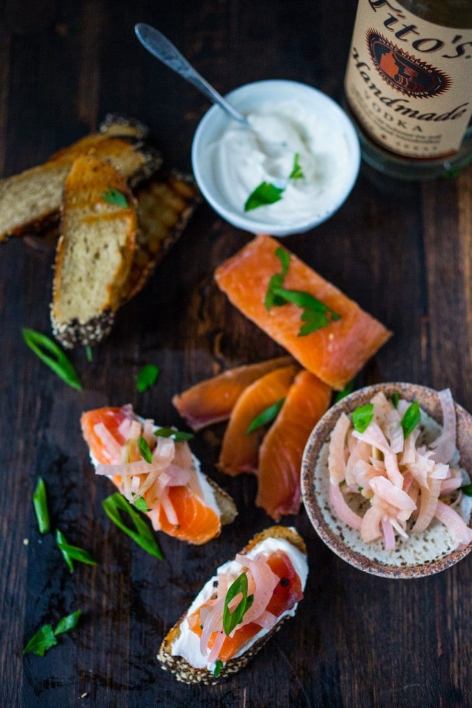 Lox and pickled fennel Bruschetta! This simple recipe for Salt Cured Salmon with rosemary, juniper berries (optional) vodka and lemon zest requires only a few minutes of prep, and then watch as nature takes its course. | www.feastingathome.com