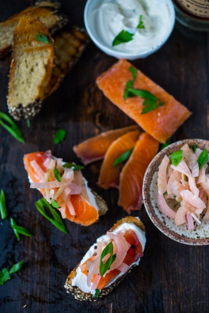 Have you ever made lox at home? It's so easy! This simple recipe for Salt Cured Salmon with rosemary, juniper berries (optional) vodka and lemon zest requires only a few minutes of prep, and then watch as nature takes its course. | www.feastingathome.com