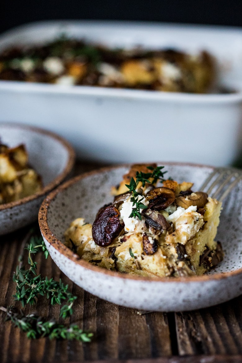 A delicious Baked Egg Casserole called Breakfast Strata with mushrooms, caramelized onions, goat cheese and thyme, perfect for the holidays. Make it ahead! | www.feastingathome.com