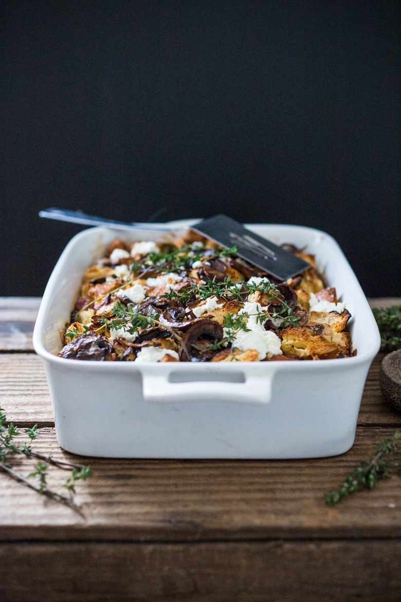 A delicious Baked Egg Casserole called Breakfast Strata with mushrooms, caramelized onions, goat cheese and thyme, perfect for the holidays. Make it ahead! | www.feastingathome.com