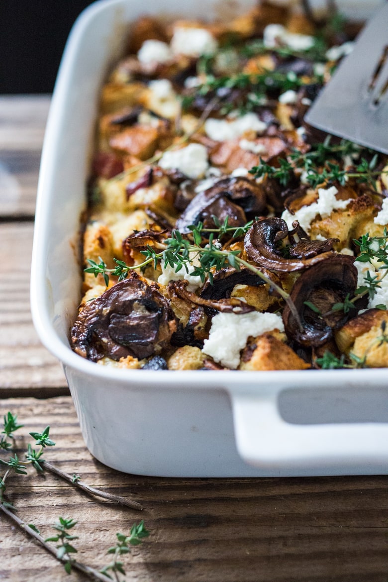 A delicious Baked Egg Casserole called Breakfast Strata with mushrooms, caramelized onions, goat cheese and thyme, perfect for the holidays. Make it ahead! | www.feastingathome.com