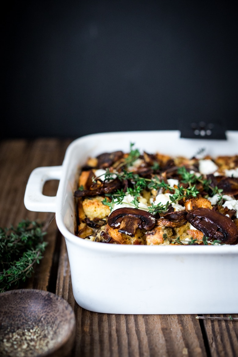 A delicious Baked Egg Casserole called Breakfast Strata with mushrooms, caramelized onions, goat cheese and thyme, perfect for the holidays. Make it ahead! | www.feastingathome.com