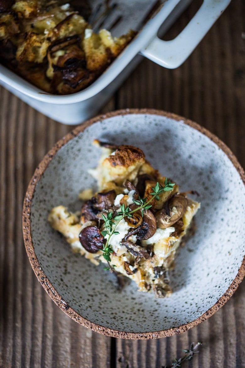 A delicious Baked Egg Casserole called Breakfast Strata with mushrooms, caramelized onions, goat cheese and thyme, perfect for the holidays. Make it ahead! | www.feastingathome.com