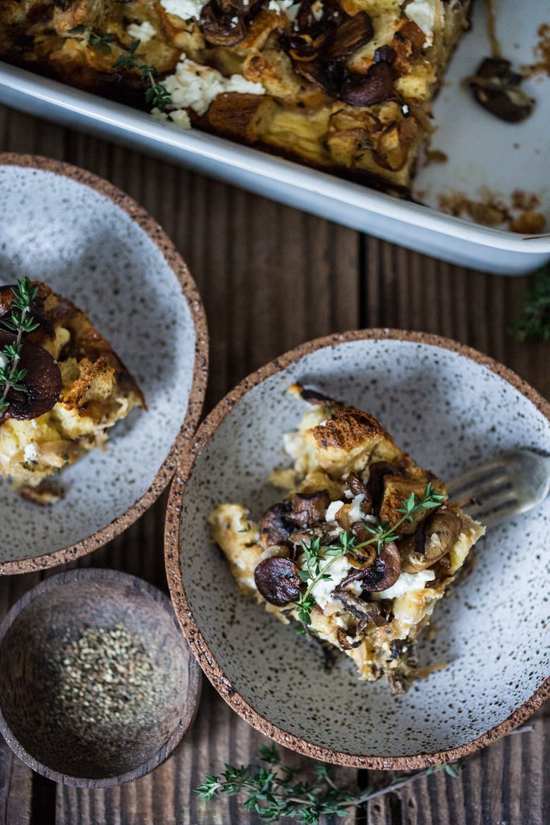 A delicious Baked Egg Casserole called Breakfast Strata with mushrooms, caramelized onions, goat cheese and thyme, perfect for the holidays. Make it ahead! | www.feastingathome.com