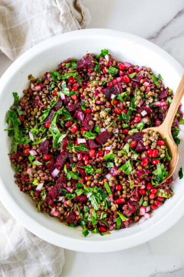 This lentil pomegranate salad is vibrant, flavorful, and packed with beets, herbs, and juicy pomegranate seeds. A healthy, protein-rich salad perfect for meal prep. Can also be served with tortilla chips for a festive appetizer dip. Vegan and Gluten-free.