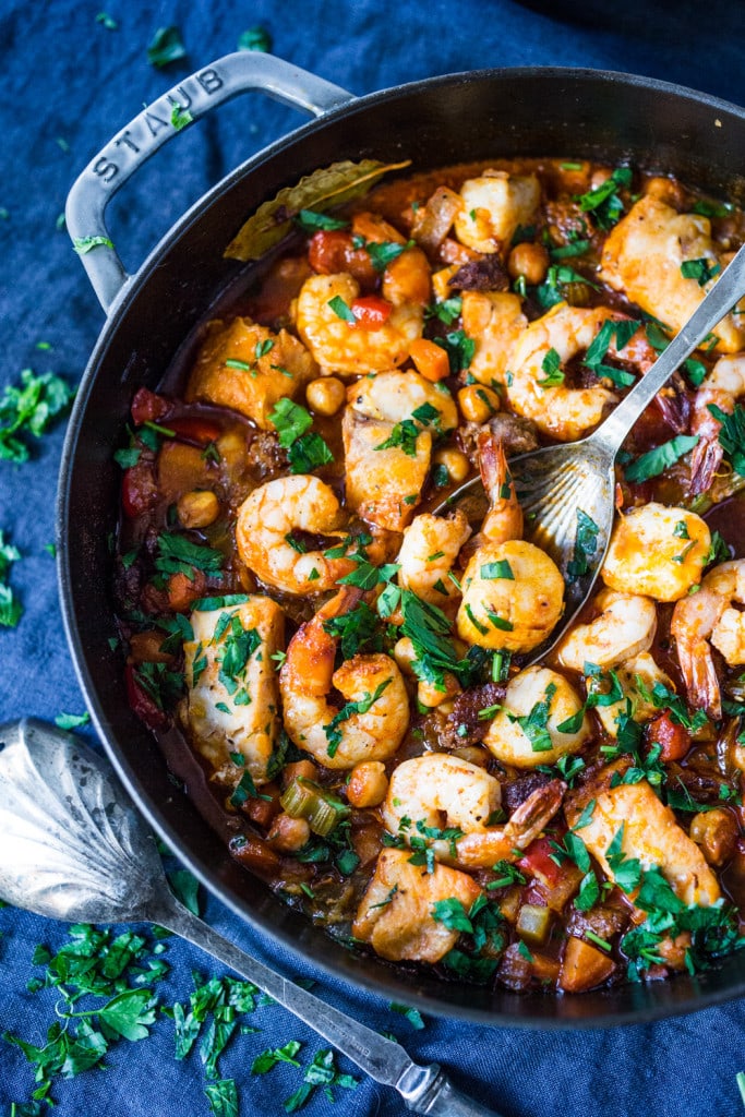 A simple delicious recipe for Spanish Seafood Stew with Garbanzo beans and Chorizo ( or soy Chorizo) served over Jasmine infused rice. | www.feastingathome.com