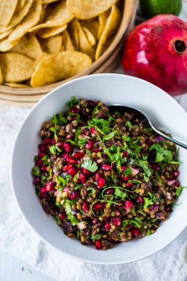 A take on "Texas Caviar", Palouse Caviar is made w/ NW Palouse lentils, pomegranate, avocado, lime & served with corn chips for a festive healthy appetizer. | www.feastingathome.com