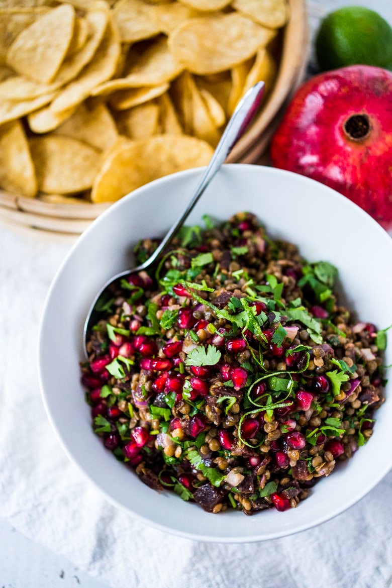 A take on "Texas Caviar", this Lentil Dip dip called Palouse Caviar is made w/ Northwest Palouse grown lentils, pomegranate, avocado, lime & served with corn chips for a festive healthy, vegan GF appetizer. | www.feastingathome.com