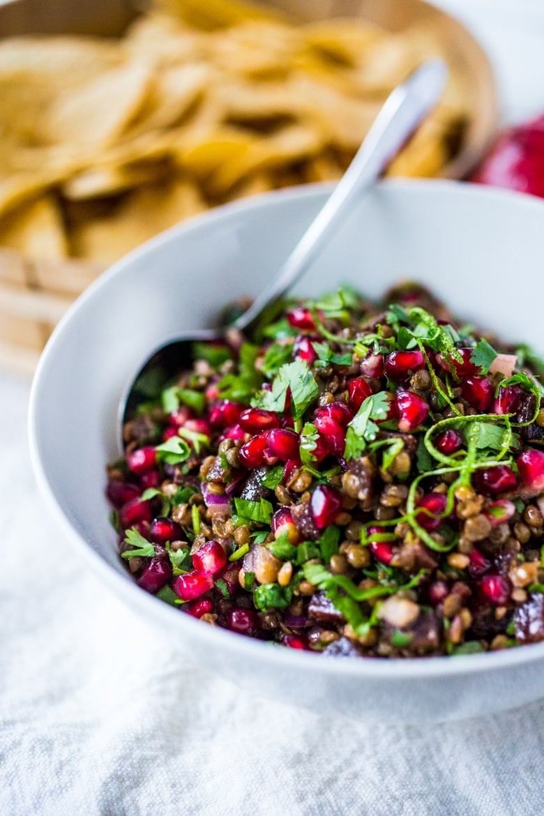 A take on "Texas Caviar", this Lentil Dip dip called Palouse Caviar is made w/ Northwest Palouse grown lentils, pomegranate, avocado, lime & served with corn chips for a festive healthy, vegan GF appetizer. | www.feastingathome.com