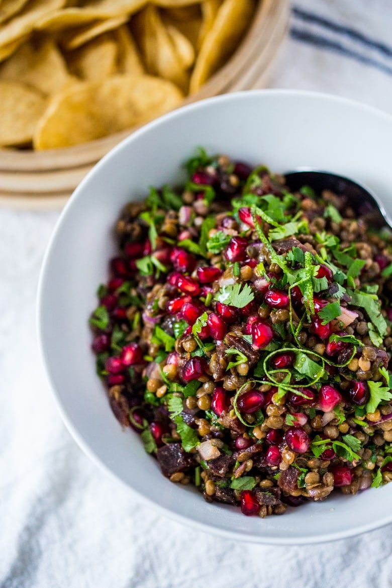 A take on "Texas Caviar", this Lentil Dip dip called Palouse Caviar is made w/ Northwest Palouse grown lentils, pomegranate, avocado, lime & served with corn chips for a festive healthy, vegan GF appetizer. | www.feastingathome.com