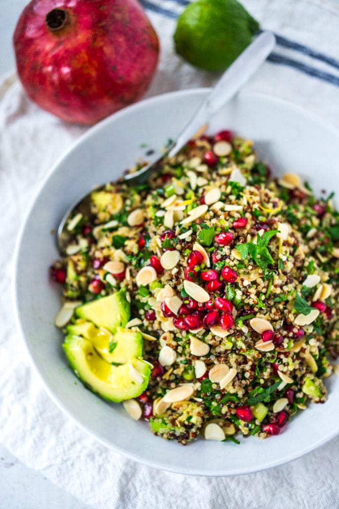 Holiday Crunch Salad - w/ Quinoa, Pomegranate Seeds, avocado, parsley and toasted Almonds...a healthy vegan gluten -free salad to your holiday table! | #vegansalad #healthysalad #christmassalad #pomegranate #quinoa #quinoasalad |www.feastingathome. com