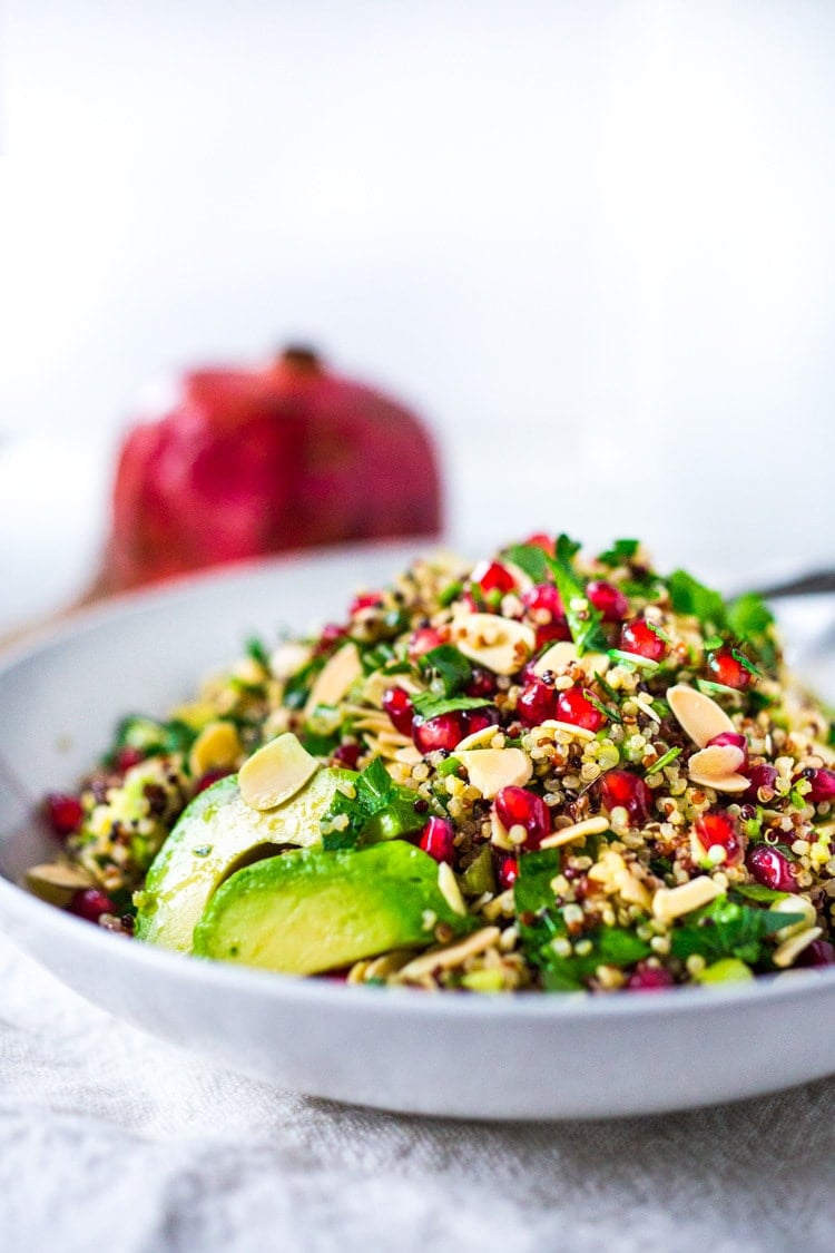 Holiday Crunch Salad - w/ Quinoa, Pomegranate Seeds, avocado, parsley and toasted Almonds...a healthy vegan gluten -free salad to your holiday table! | #vegansalad #healthysalad #christmassalad #pomegranate #quinoa #quinoasalad |www.feastingathome. com