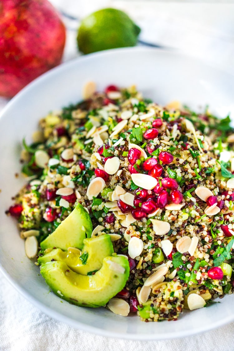 Holiday Crunch Salad - w/ Quinoa, Pomegranate Seeds, avocado, parsley and toasted Almonds...a healthy vegan gluten -free salad to your holiday table! | #vegansalad #healthysalad #christmassalad #pomegranate #quinoa #quinoasalad |www.feastingathome. com