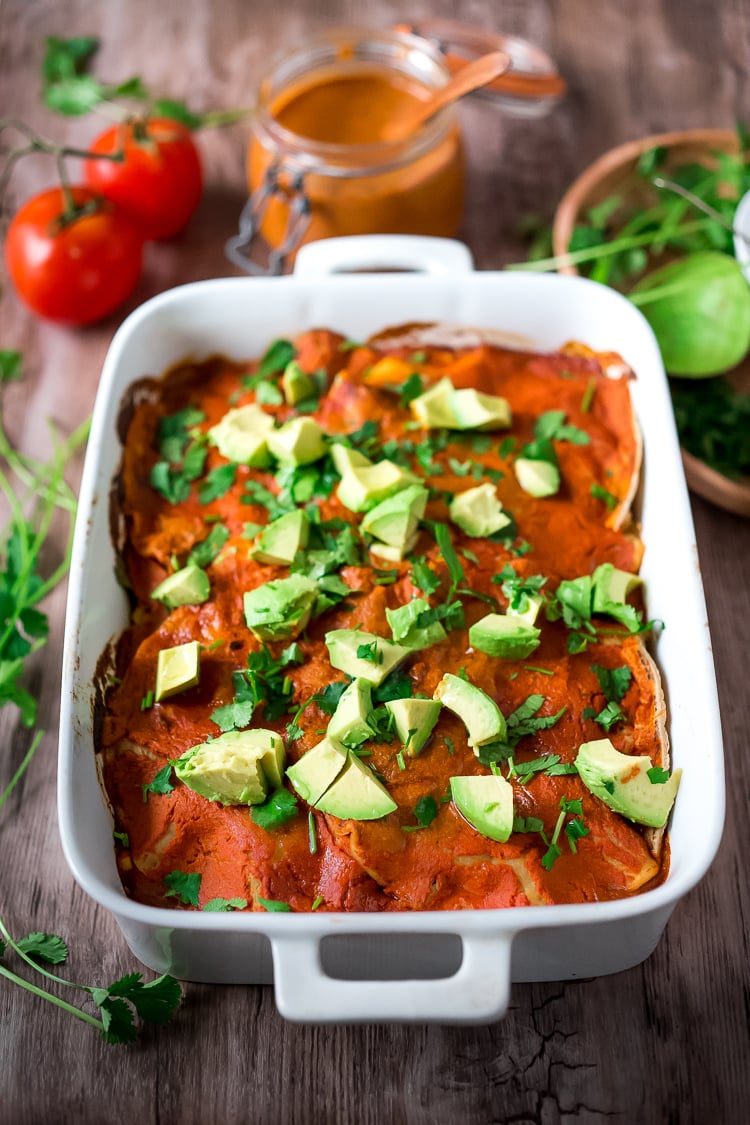 Simple Enchilada Casserole w/ Two Minute Enchilada Sauce! A fast and healthy version of enchiladas  made with layered tortillas instead of rolled- very time saving! Keep it vegetarian or add chicken! | www.feastingathome.com #enchilada #enchiladacassarole #enchiladas #vegetarian #chickenenchiladas