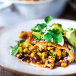 Simple Enchilada Casserole w/ Two Minute Enchilada Sauce! A fast and healthy version of enchiladas  made with layered tortillas instead of rolled- very time saving! Keep it vegetarian or add chicken! | www.feastingathome.com #enchilada #enchiladacassarole #enchiladas #vegetarian #chickenenchiladas