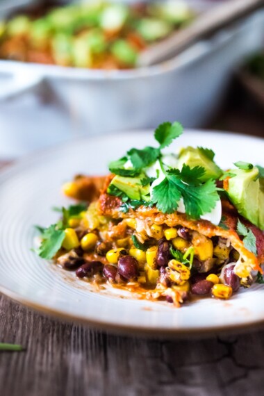 Simple Enchilada Casserole w/ Two Minute Enchilada Sauce! A fast and healthy version of enchiladas  made with layered tortillas instead of rolled- very time saving! Keep it vegetarian or add chicken! | www.feastingathome.com #enchilada #enchiladacassarole #enchiladas #vegetarian #chickenenchiladas