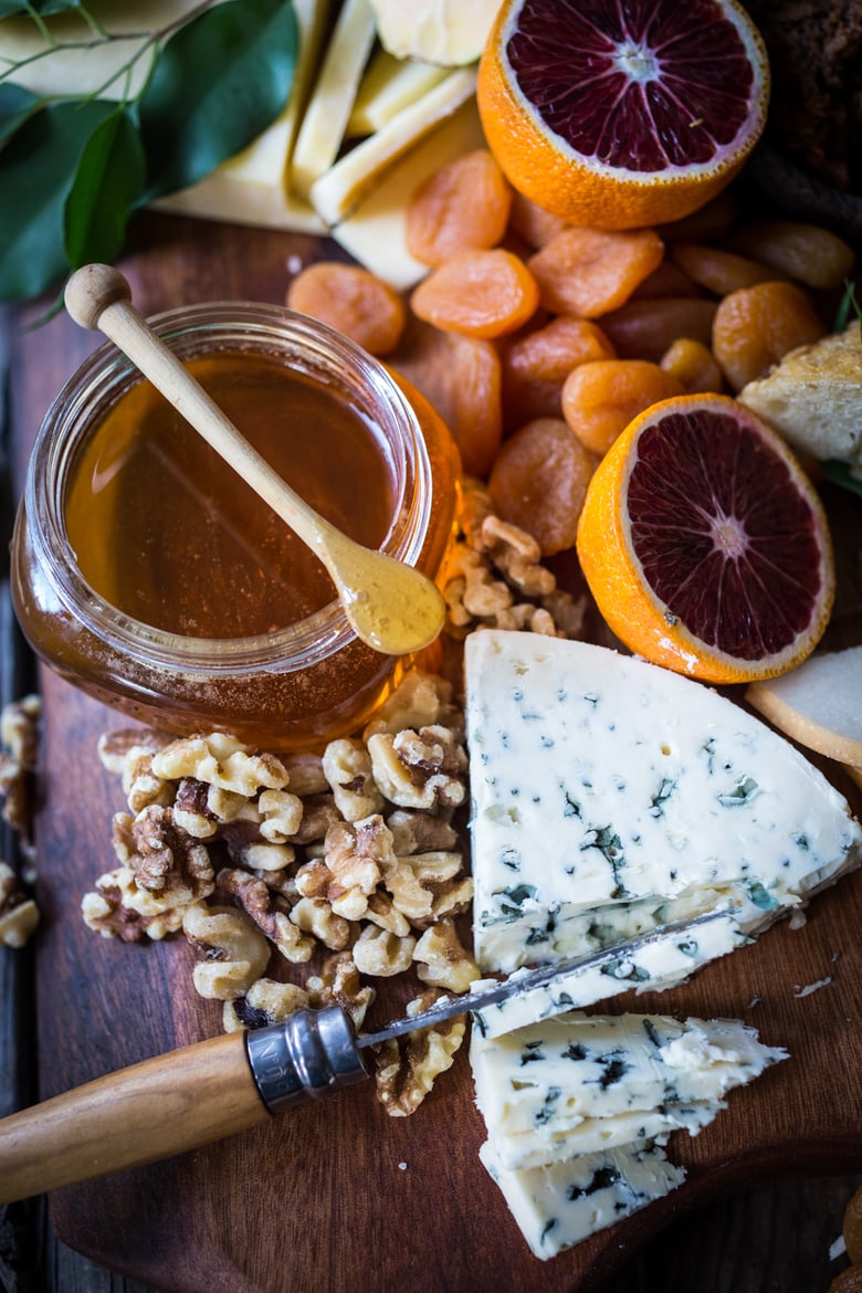 A Winter Cheese Board with Blood Orange Marmalade and Castello cheeses, winter fruits, nuts honey and Folie a Duex Wine....a match made in heaven. | www.Feastingathome.com 