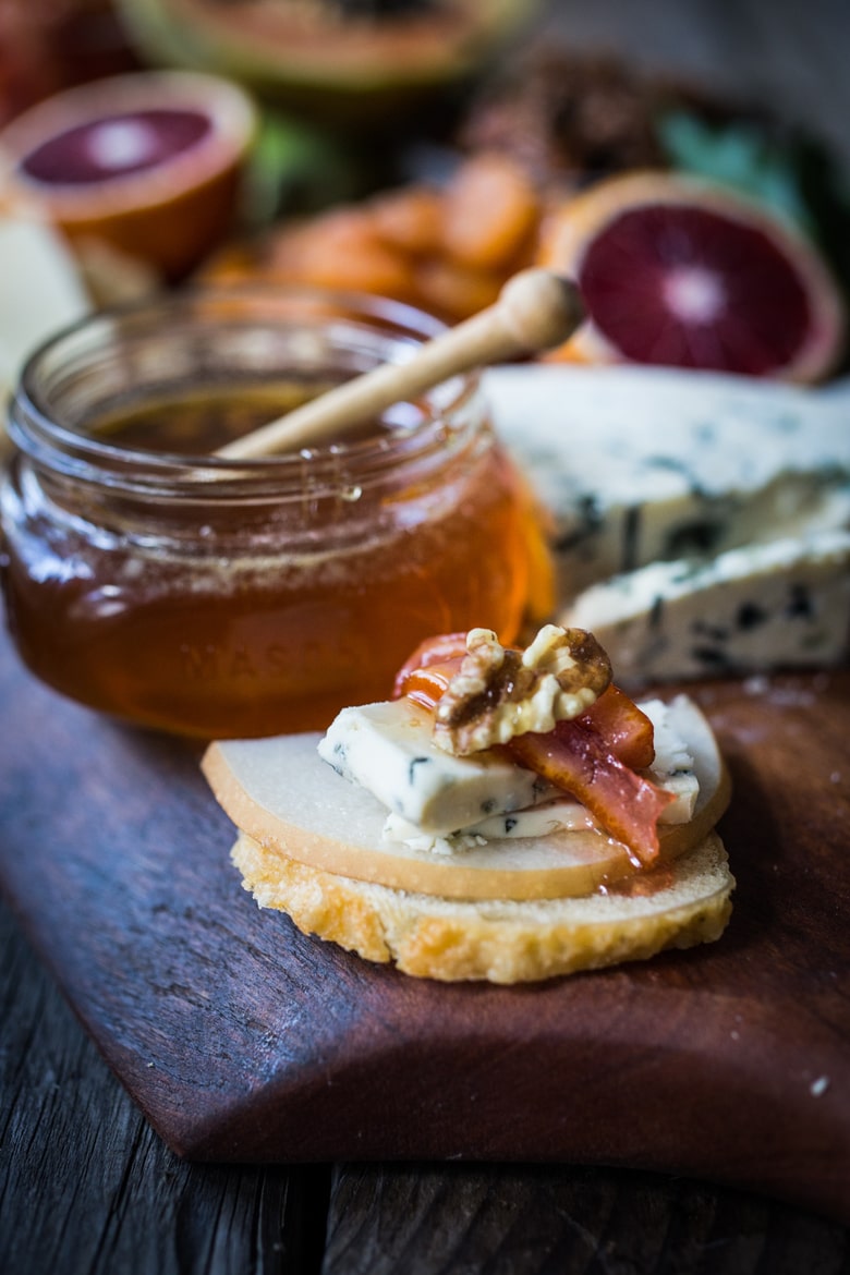A Winter Cheese Board with Blood Orange Marmalade and Castello cheeses, winter fruits, nuts and honey...a match made in heaven. | www.Feastingathome.com 
