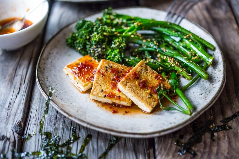 A Tasty recipe for Garlic Chili Tofu with Sesame Broccolini- a delicious and fast, 15 minute dinner that is vegan and gluten free. Healthy & Yummy! | www.feastingathome.com