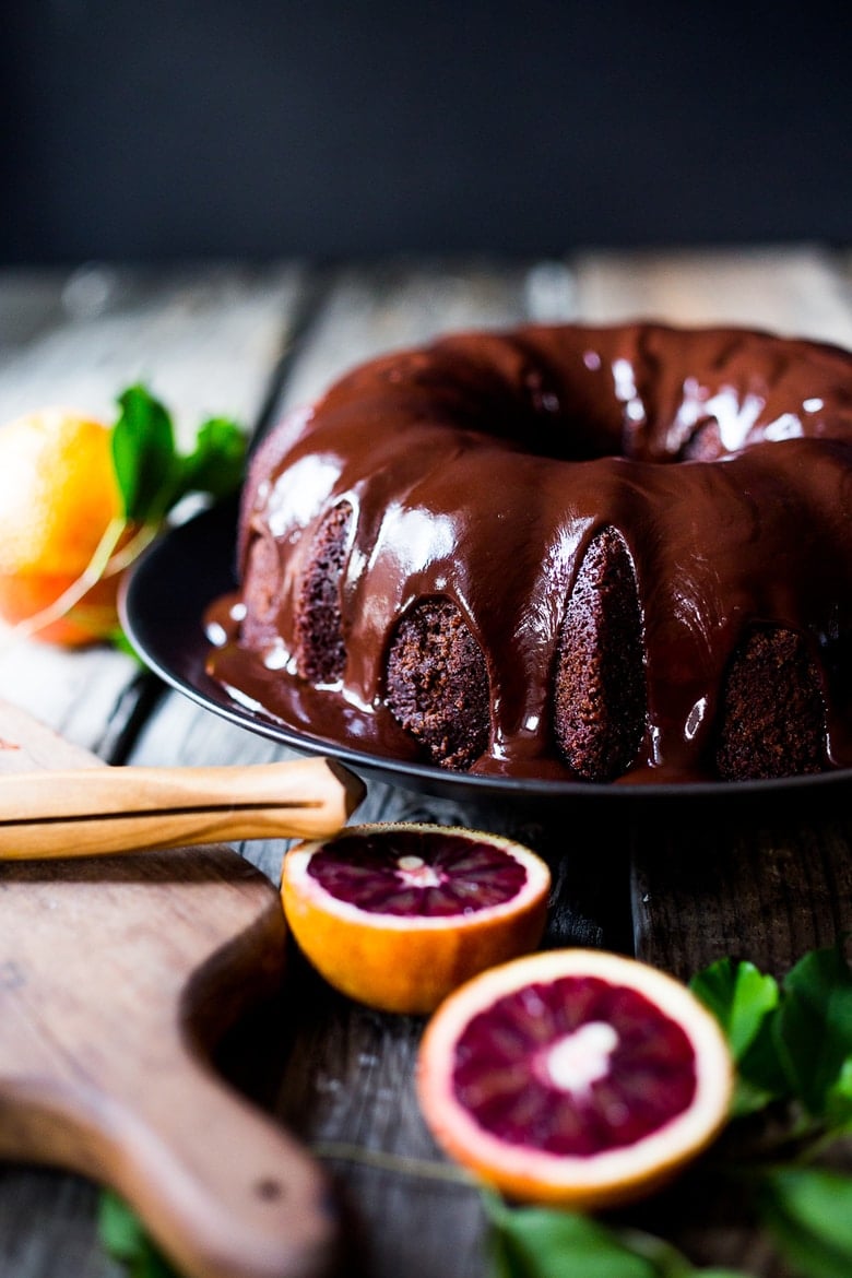 Dark Chocolate Bundt Cake with Blood Oranges and a Chocolate Ganache icing. Simple, moist, flavorful and absolutely scrumptious!  You will be the hero of the potluck with this one!